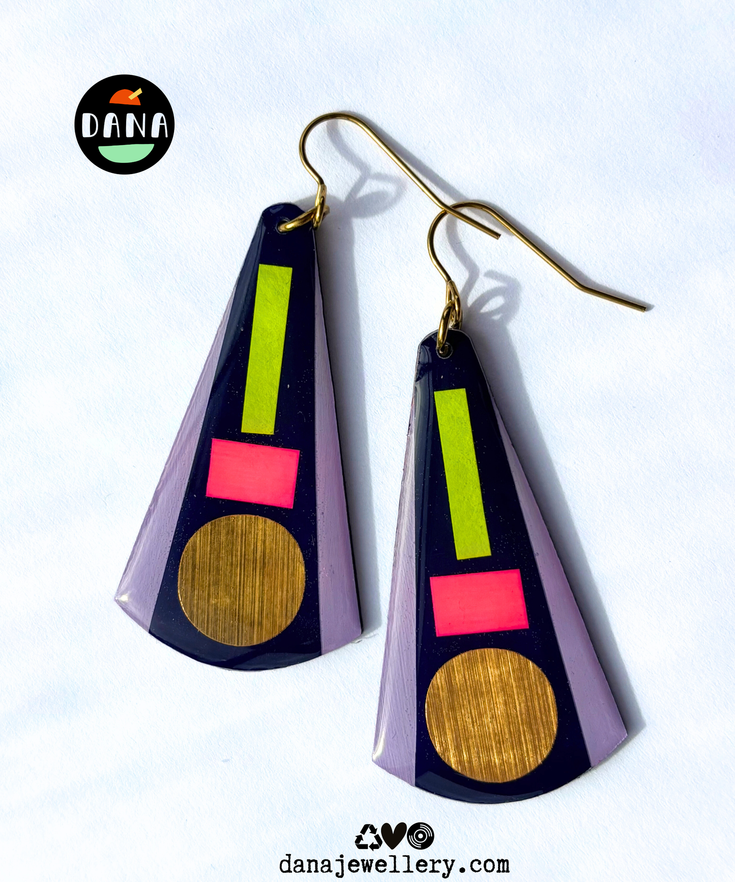 KAY in deep navy blue, neon pink, neon yellow, lilac, gold