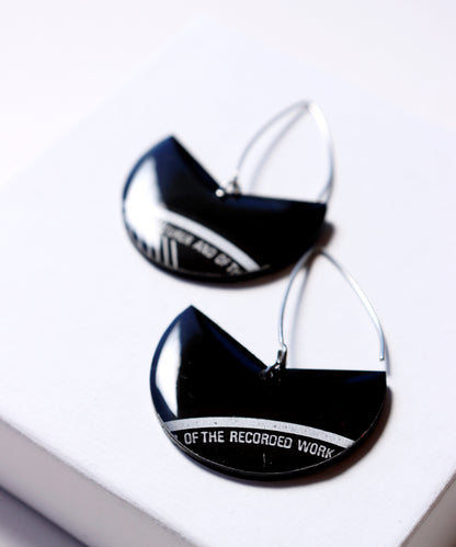 Elegant upcycled black vinyl record earrings with a subtle hint of silvery grey label