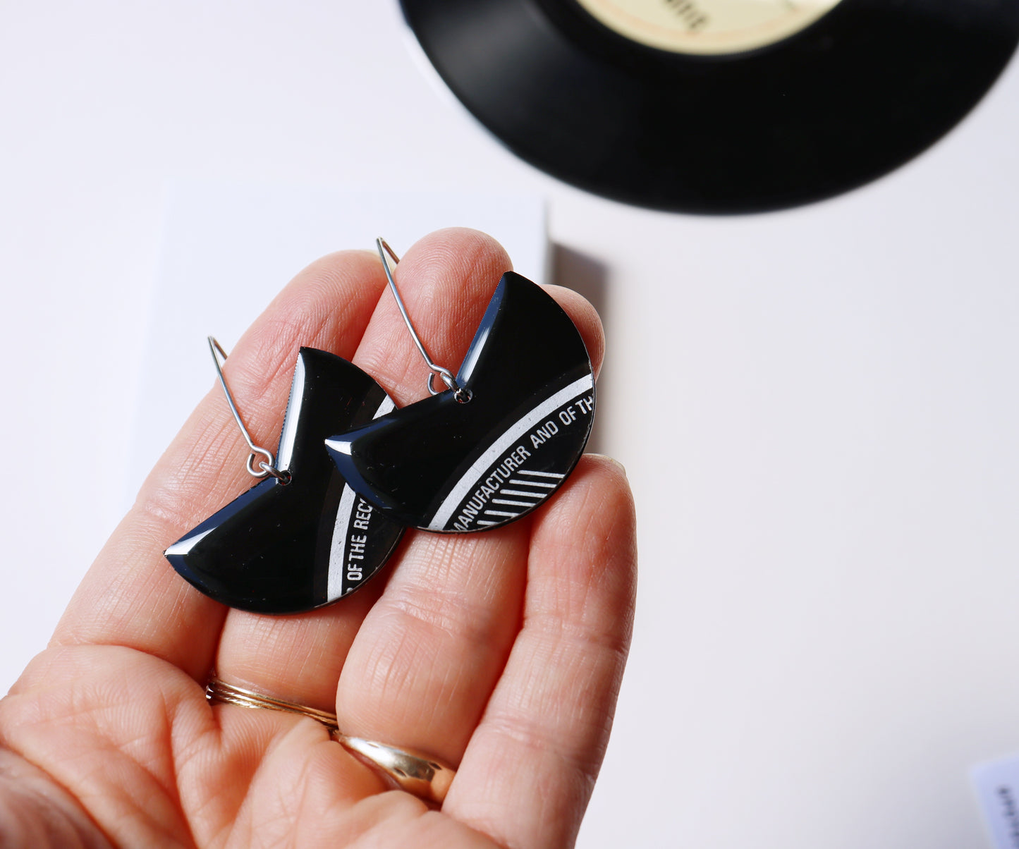 Elegant upcycled black vinyl record earrings with a subtle hint of silvery grey label