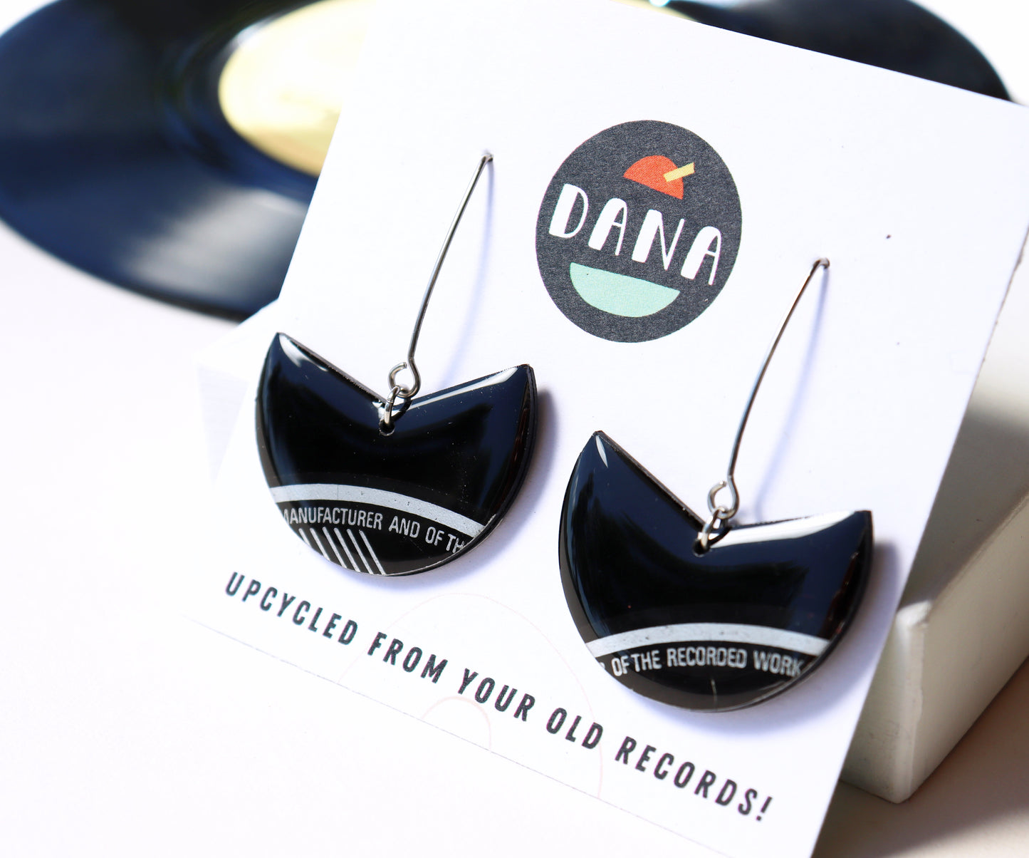 Elegant upcycled black vinyl record earrings with a subtle hint of silvery grey label