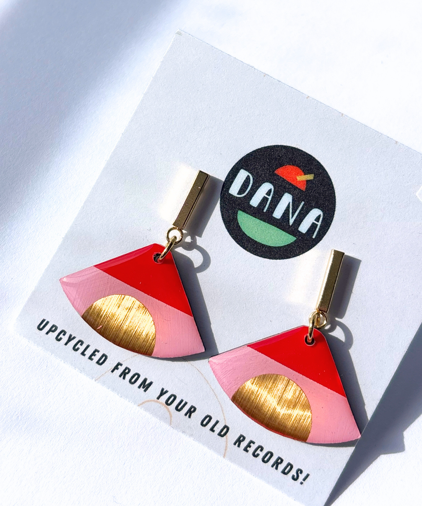 ISLA in pink, red, and gold