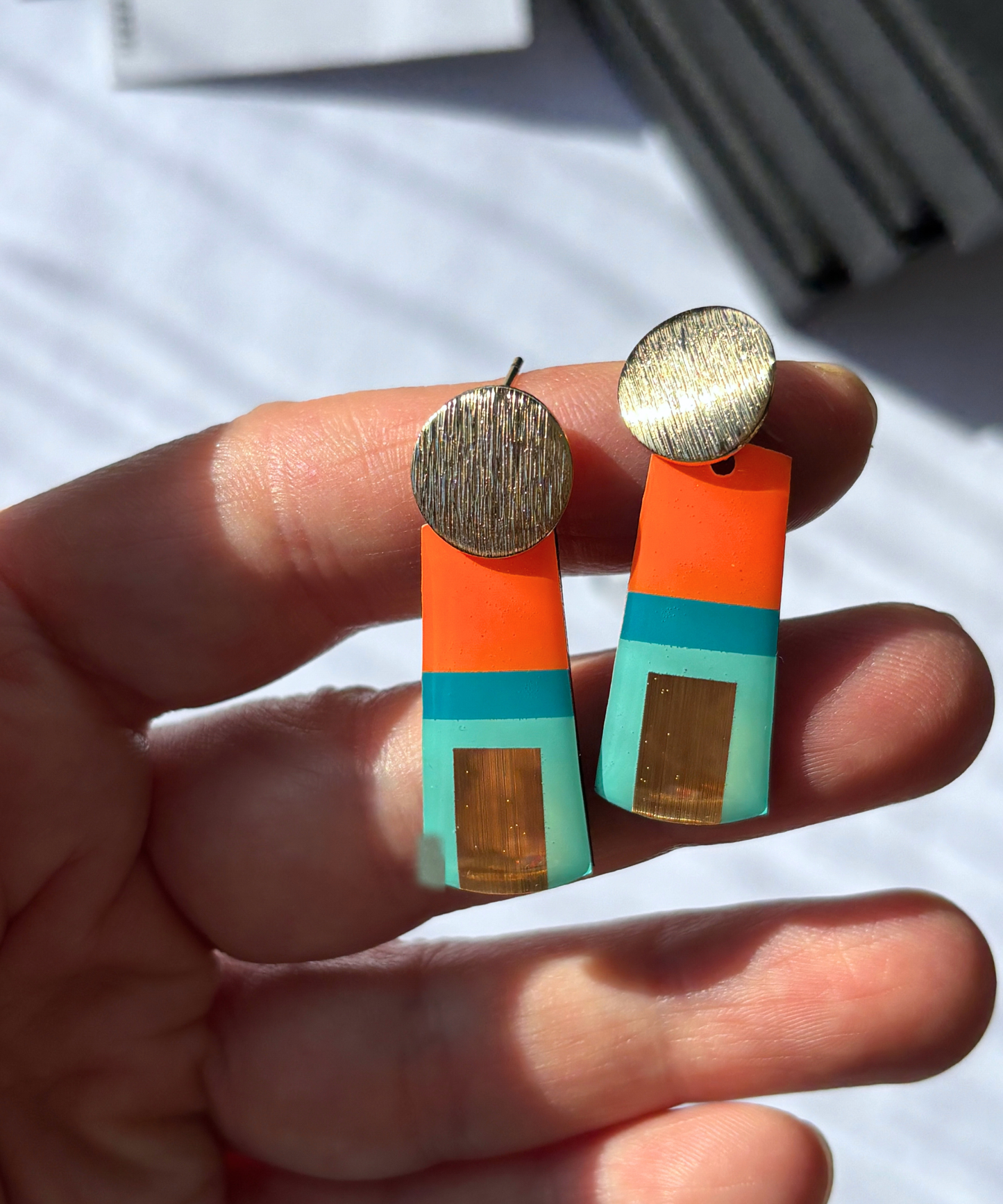 MAE in teal, turquoise, orange, gold