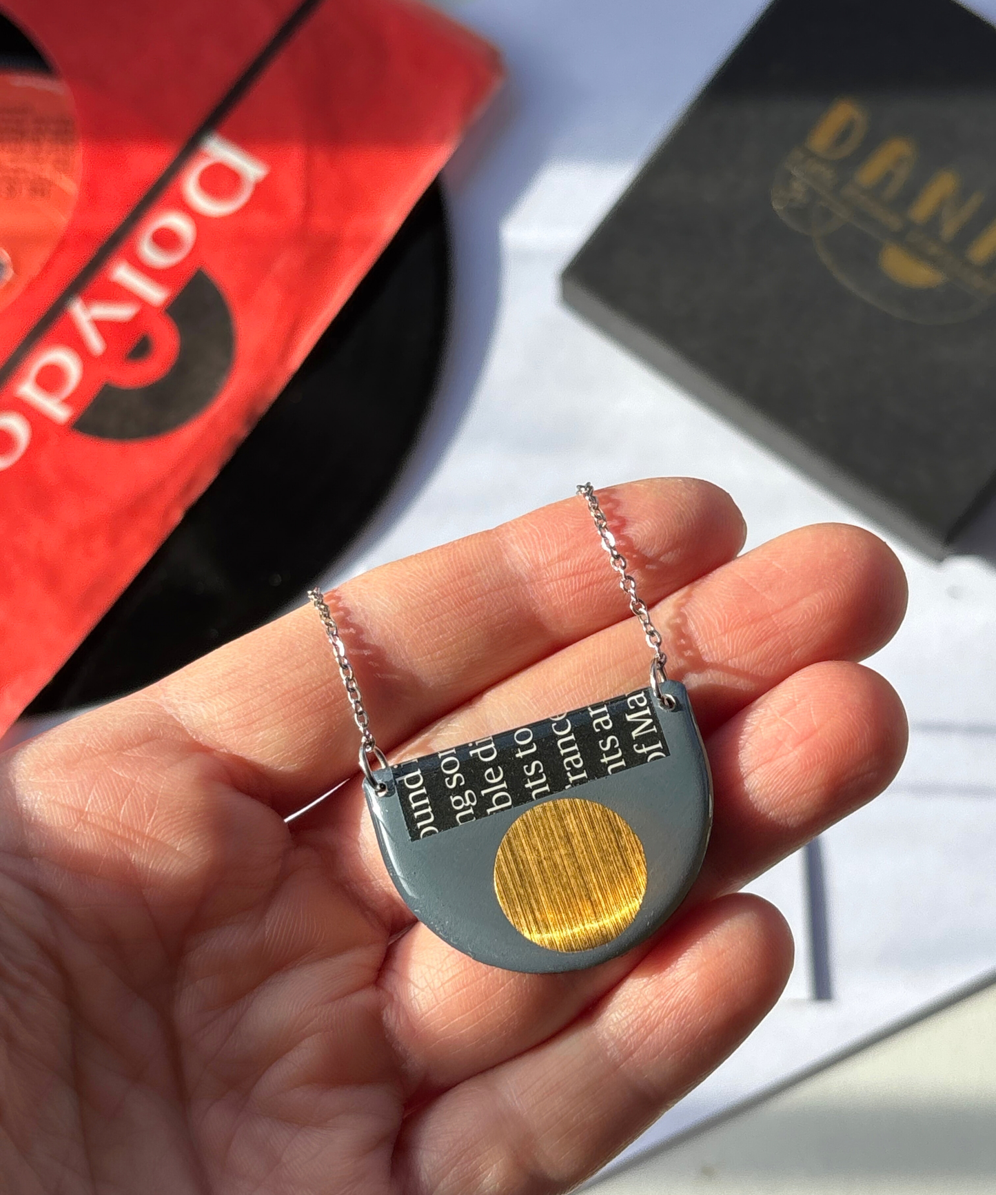 40% OFF graphic necklace in deep blue grey, gold and a hint of magazine paper