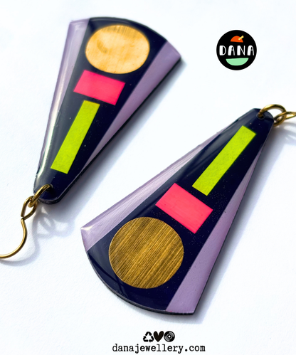 KAY in deep navy blue, neon pink, neon yellow, lilac, gold