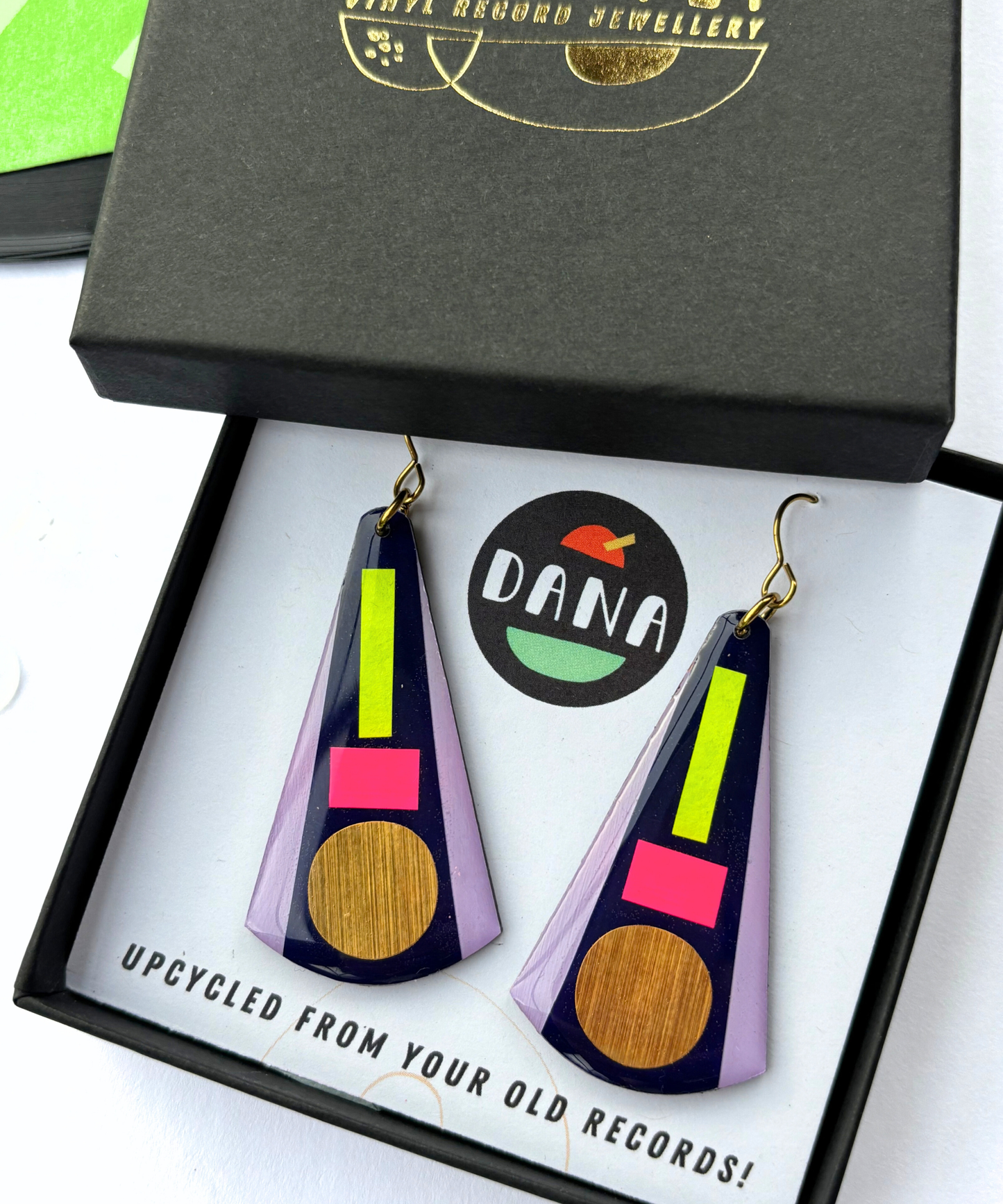 KAY in deep navy blue, neon pink, neon yellow, lilac, gold