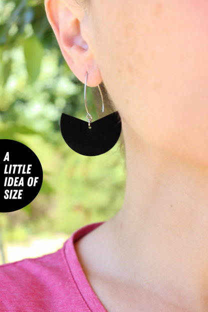 Elegant upcycled black vinyl record earrings with a subtle hint of silvery grey label